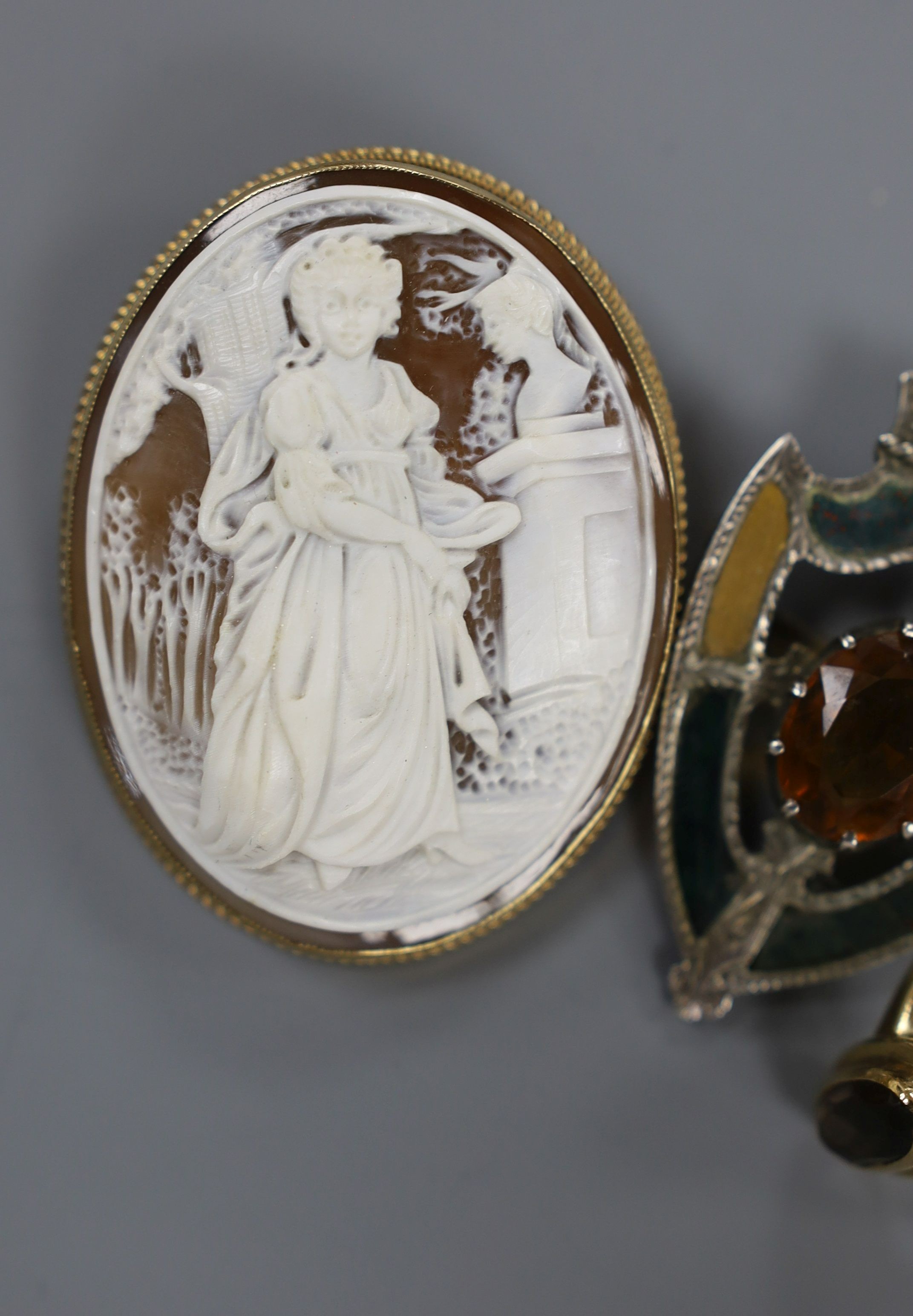 A modern 9ct gold mounted oval cameo shell brooch, 53mm, a 9ct gold and gem set ring and a white metal, gem and Scottish hardstone set shield shaped brooch